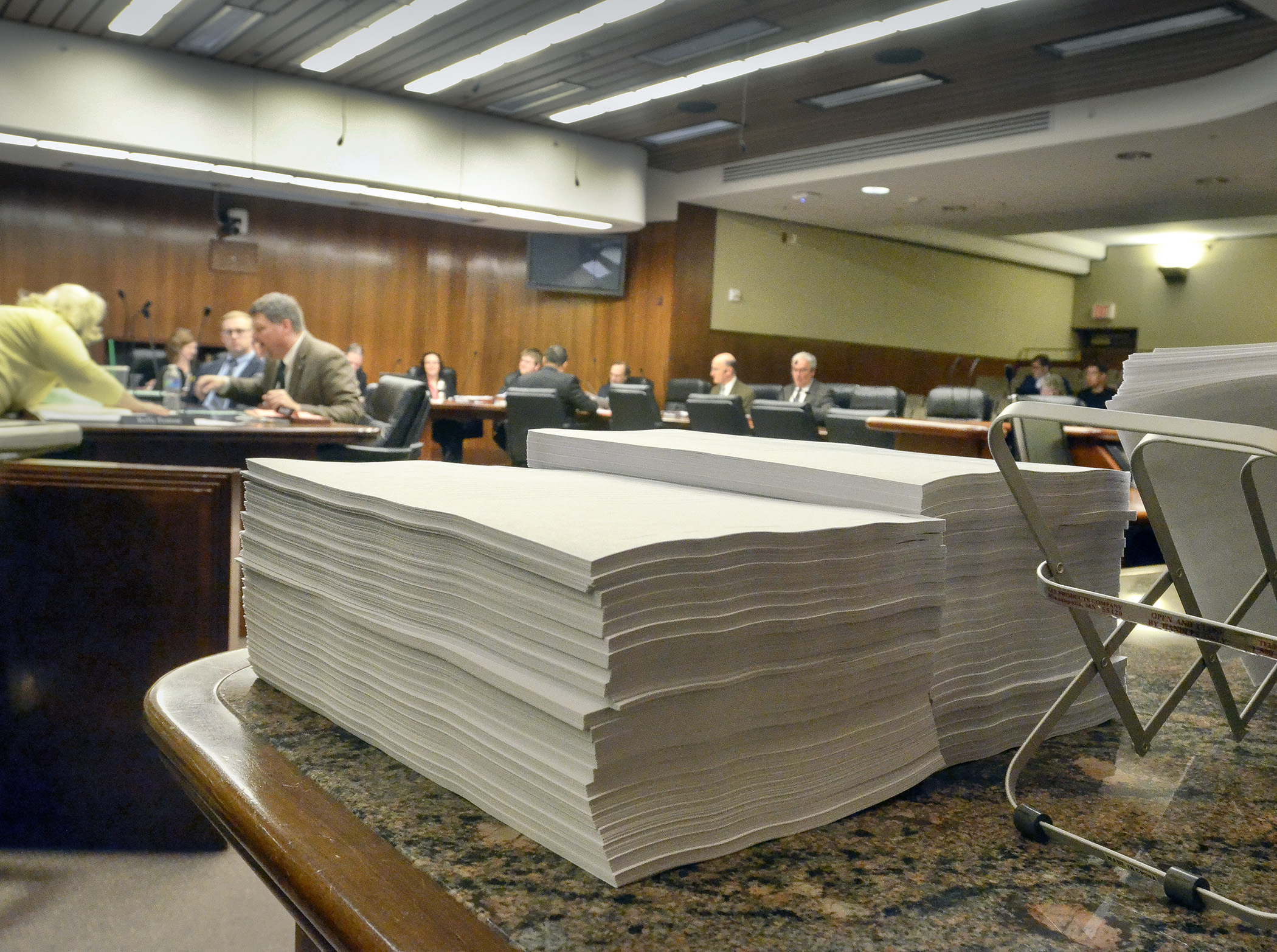 Copies of the omnibus environment finance bill await distribution prior to an April 14 House Environment and Natural Resources Policy and Finance Committee walk-through. Photo by Andrew VonBank